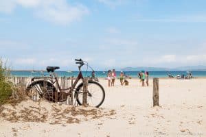 Bicycle and people on the Alghero beach